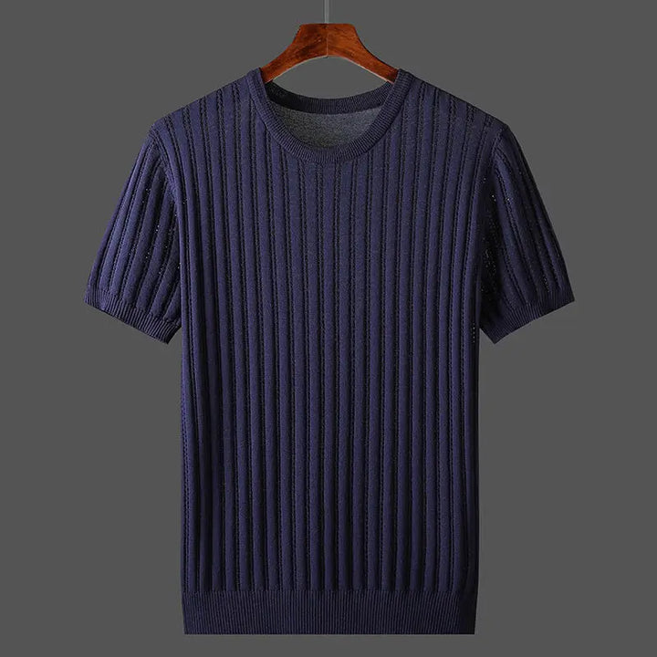 A short-sleeve, ribbed knit navy blue sweater with a classic fit hangs on a wooden hanger against a plain gray background.