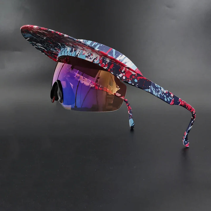 A pair of sunglasses with a wide, flat, colorful brim attached, featuring a splatter paint design in red, blue, and white, polarized lenses for UV400 protection and reflective finish, displayed against a black background.