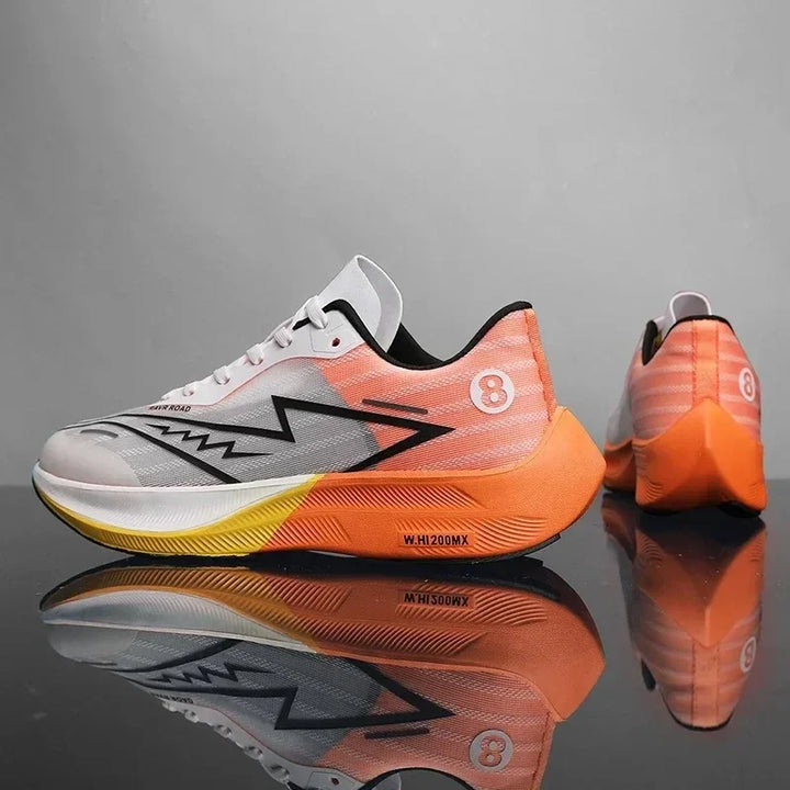 A pair of modern running shoes with gradient orange, yellow, and white coloring, black zigzag side design, number 8 on the heel, lightweight construction, and reflective details, displayed on a shiny surface against a gray background.