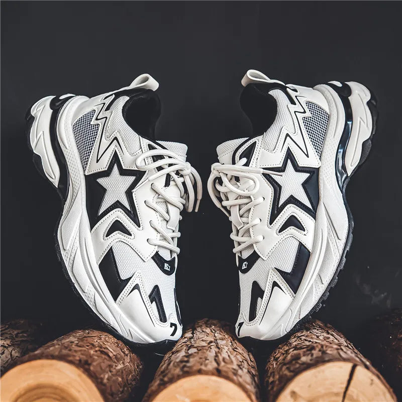 A pair of stylish white and black sneakers with star designs, featuring a breathable mesh upper, rests on cut wooden logs against a dark background.