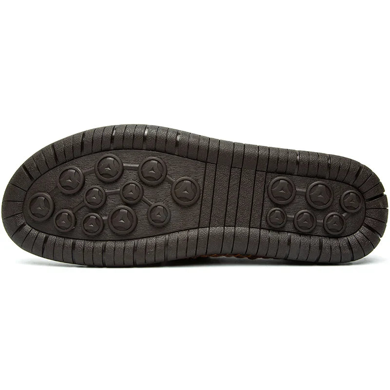 A sole of a shoe, often found in leather loafers, showcases detailed stitching that reflects traditional craftsmanship.