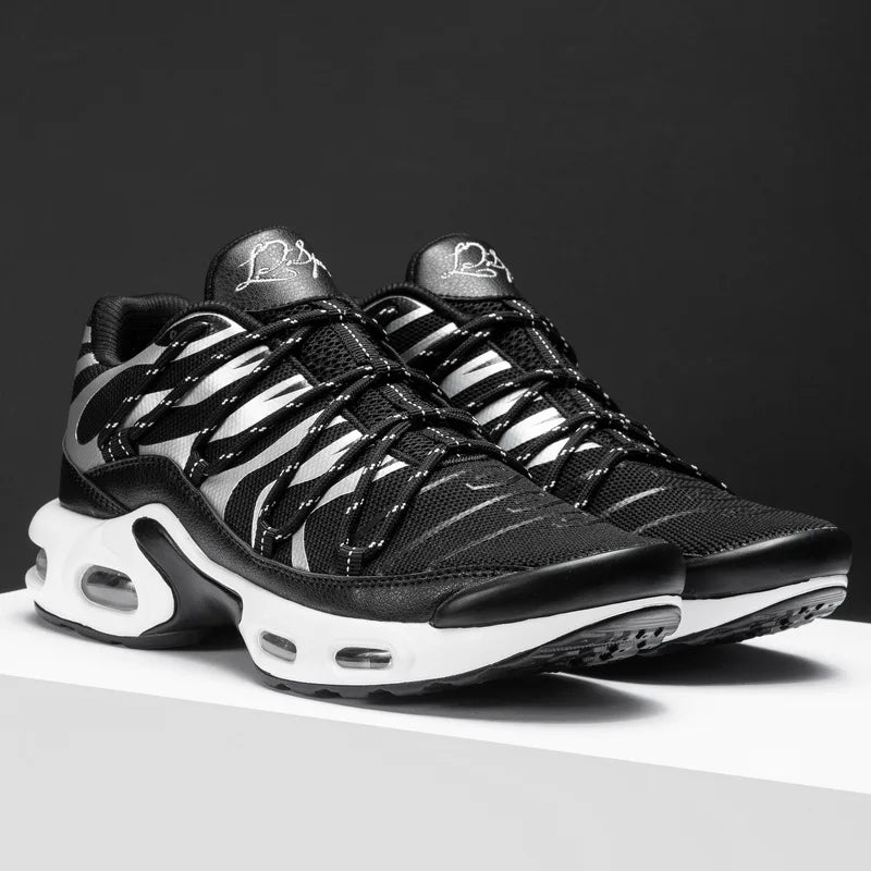 A pair of black athletic sneakers with white accents and a wavy striped pattern, featuring a breathable mesh upper, thick white soles with visible air cushions, displayed on a white surface against a dark background.