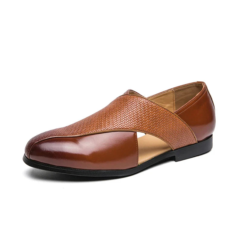 A brown genuine leather loafer with a textured crisscross design on the upper and a flat black sole, shown on a white background.