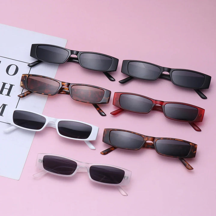 Six pairs of retro rectangle sunglasses in different colors (black, tortoiseshell, red, white, brown, and transparent) with UV400 protection are arranged on a pink surface next to a white sheet with black letters.
