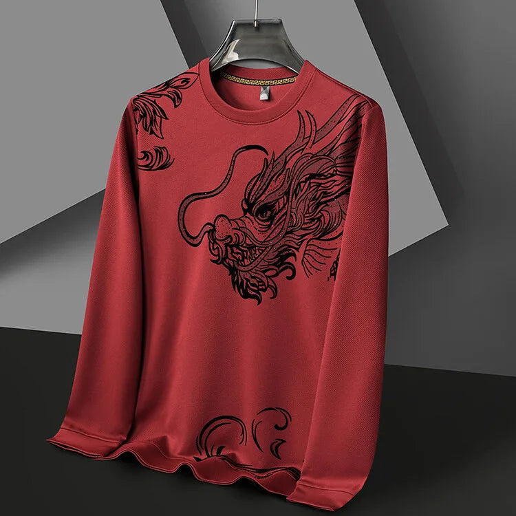 A red mens crewneck hangs on a hanger, featuring a large, detailed black dragon design across the front. The background consists of geometric gray shapes.