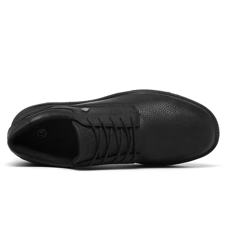 Top view of a black leather sneaker with a textured surface, black laces, and a rounded toe. Featuring a breathable mesh lining, this shoe is comfortable and casual, suitable for everyday wear.