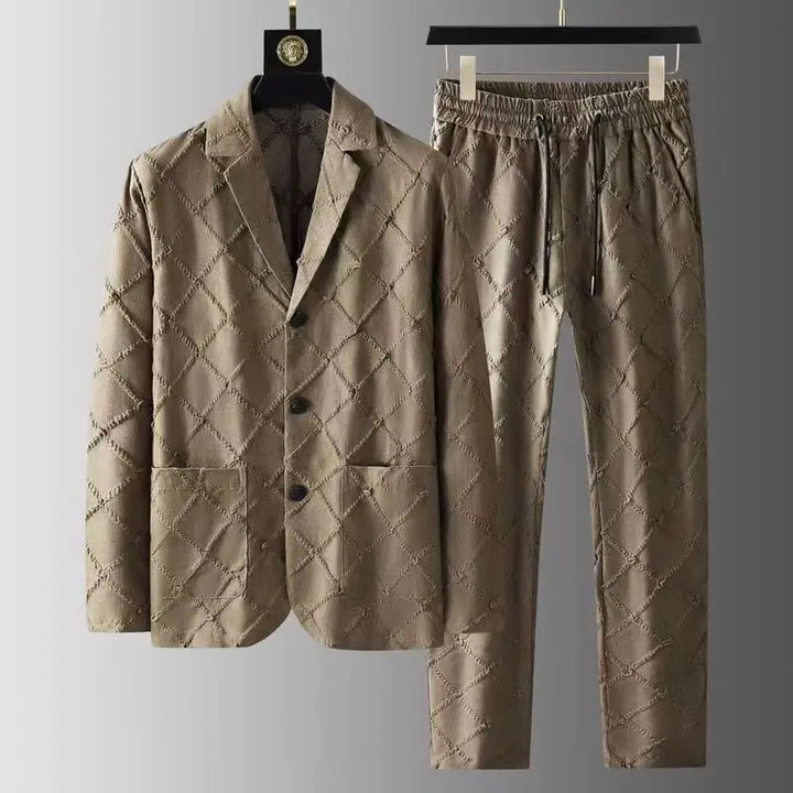 A luxury two-piece set featuring a quilted, light brown blazer and relaxed fit trousers with a diamond-patterned stitched design, displayed on black hangers against a neutral background.