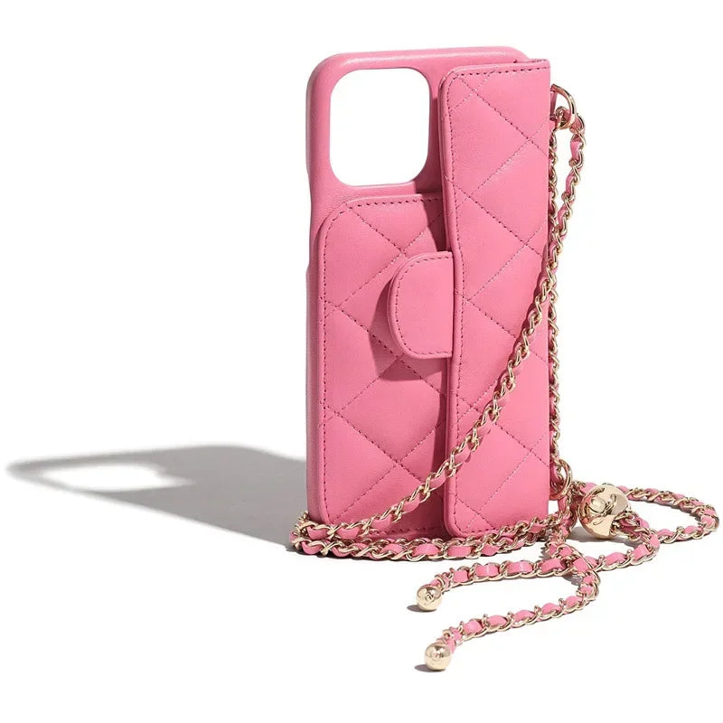 A quilted pink phone case with a stylish chain strap and gold accents, styled upright on a white background.