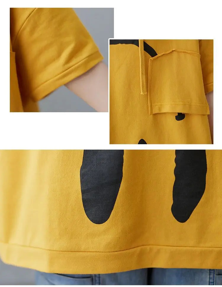 Close-up of a yellow t-shirt with black abstract designs, featuring short sleeves, a small chest pocket, and the lower hem paired with blue jeans—perfect for highlighting fresh spring colors.