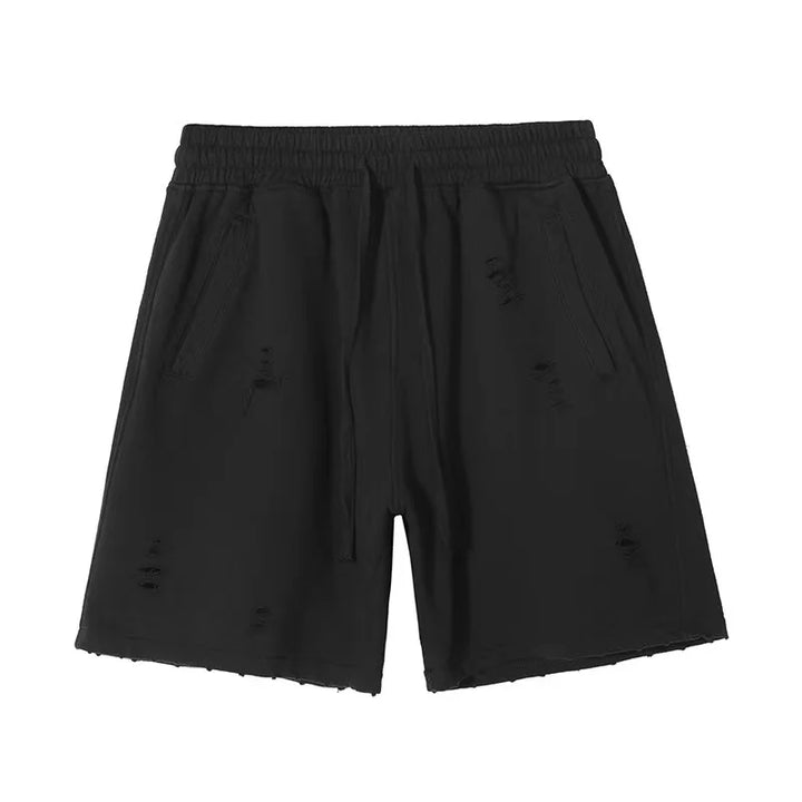 Black distressed shorts with an elastic waistband, drawstring, and two side pockets. The cut-up design and frayed details give these vintage baggy shorts a worn, casual look.