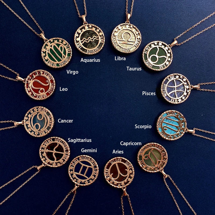 Twelve gold astrology jewelry zodiac necklaces arranged in a circle on a dark blue background, each labeled with its astrological sign name, including Aquarius, Libra, Taurus, Pisces, Scorpio, and others.