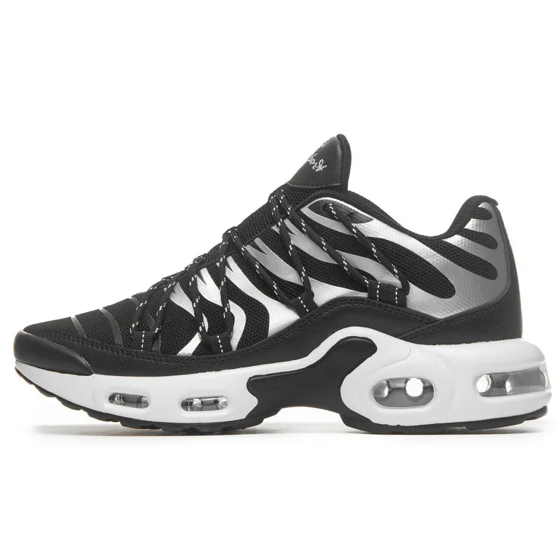 A black and white athletic sneaker with a wavy striped design, breathable mesh upper, visible air cushioning in the sole, and a low-cut silhouette.