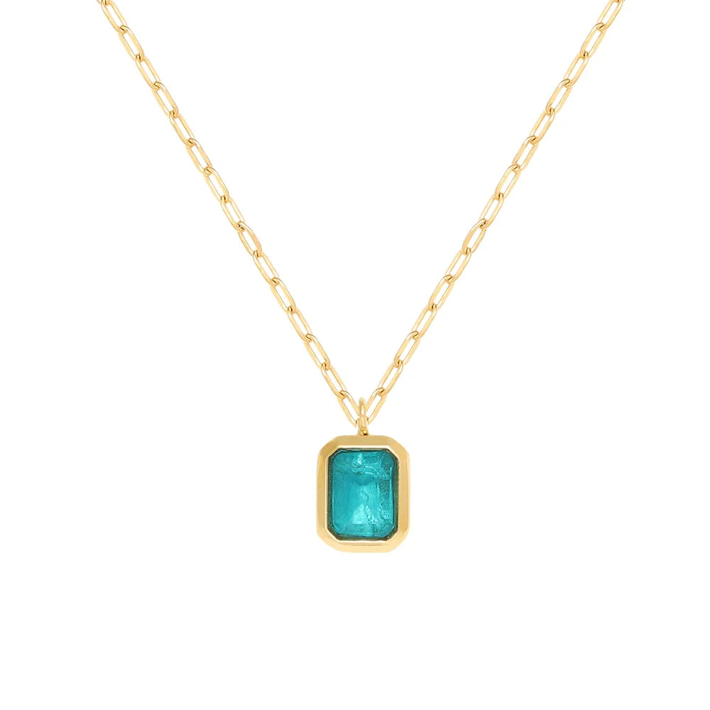 A gold chain necklace featuring a rectangular turquoise gemstone pendant set in an 18K gold plated bezel. The chain has elongated links and the vibrant blue-green gemstone adds a striking touch to this hypoallergenic accessory.