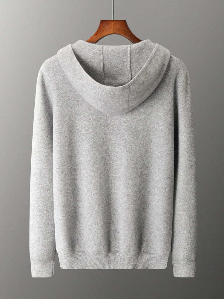 A plain light gray hooded sweatshirt, ideal as an autumn winter cardigan, is displayed on a wooden hanger against a gray background, shown from the back.