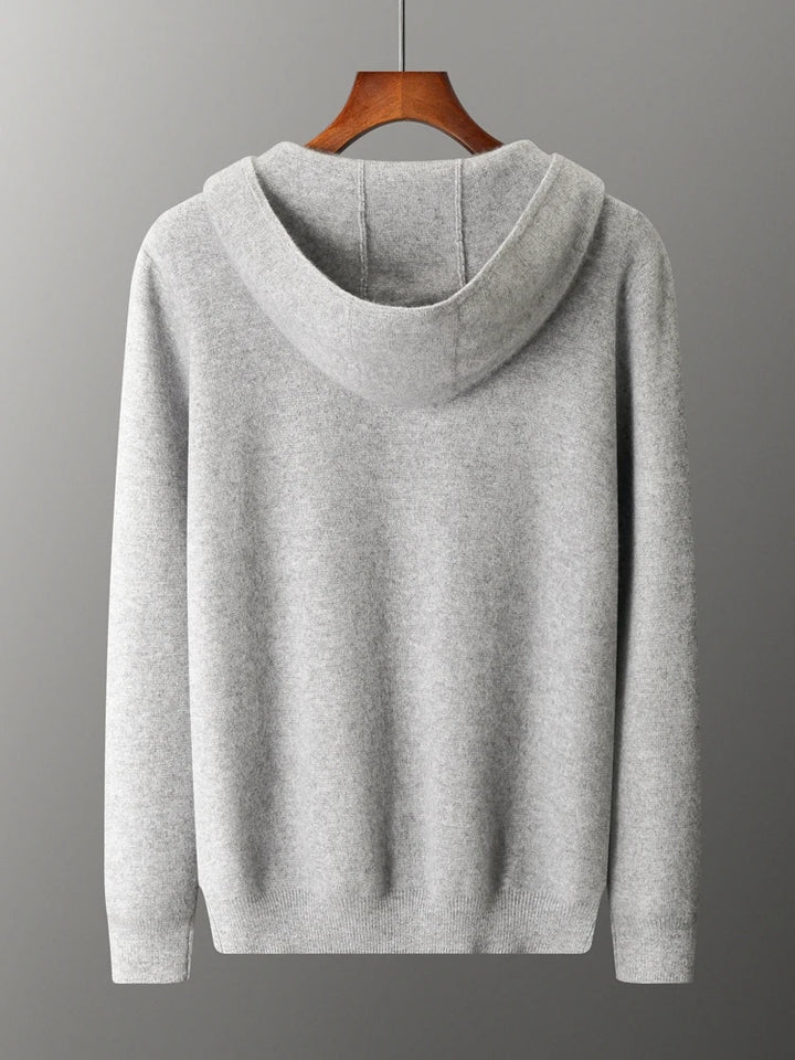 A plain light gray hooded sweatshirt, ideal as an autumn winter cardigan, is displayed on a wooden hanger against a gray background, shown from the back.