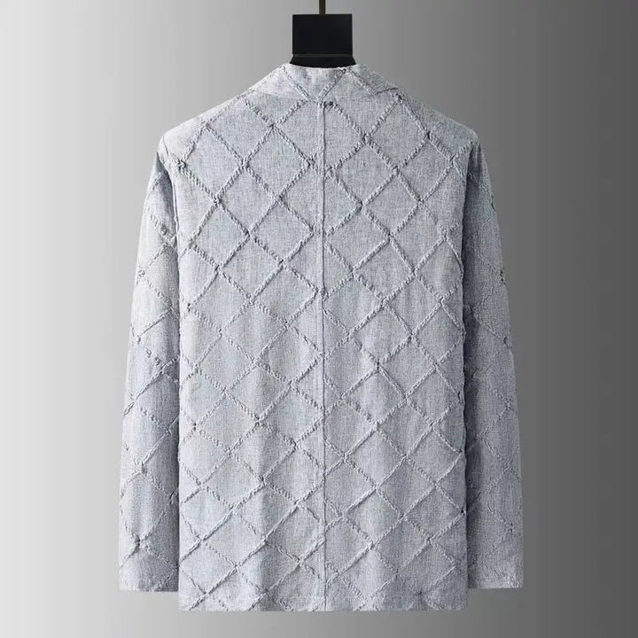 A light gray textured blazer with a quilted diamond pattern, shown from the back on a hanger against a gradient gray background.