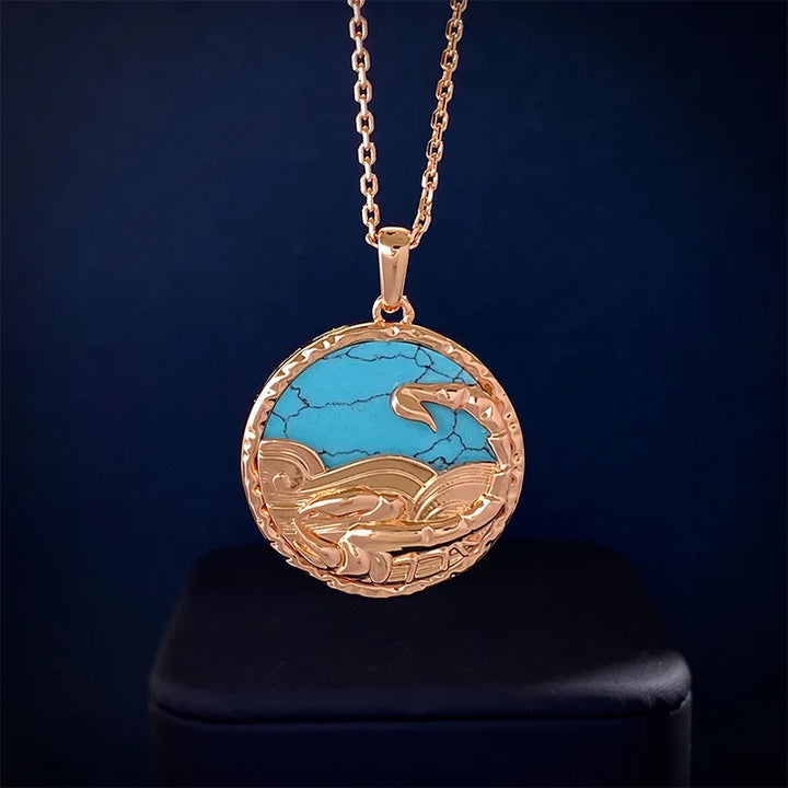 A round gold pendant with a chain, featuring a turquoise stone inlaid with gold waves and a whale tail design, this zodiac necklace is beautifully displayed against a dark background.