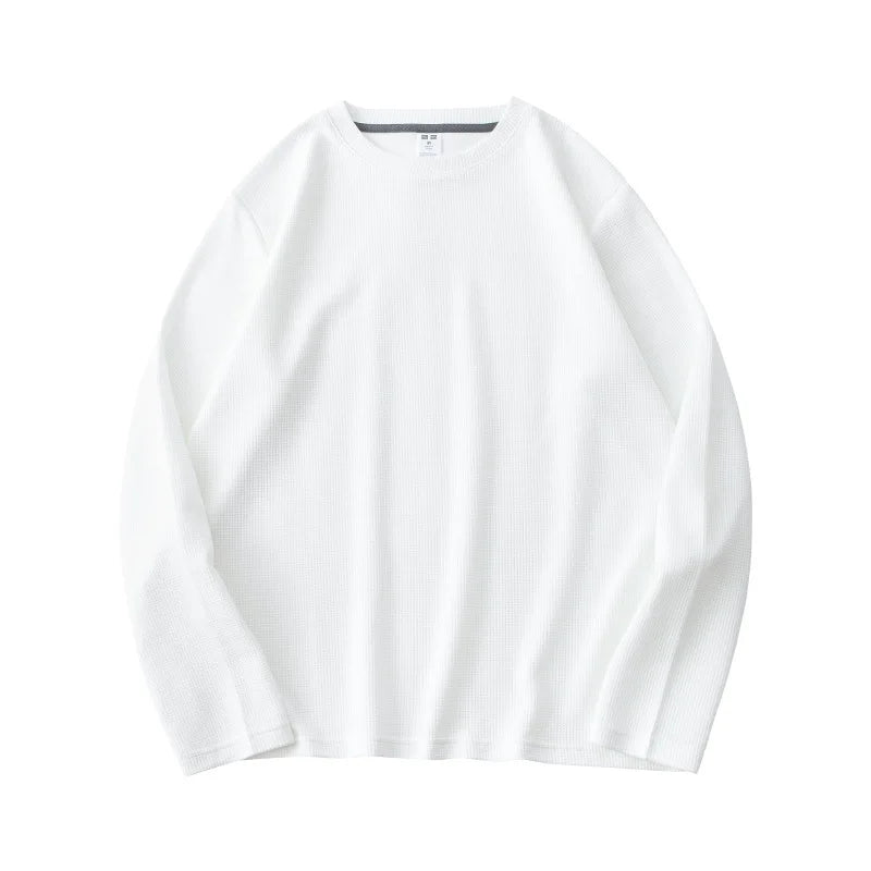 A plain white heavyweight long-sleeve shirt made from premium cotton, laid flat on a white background.