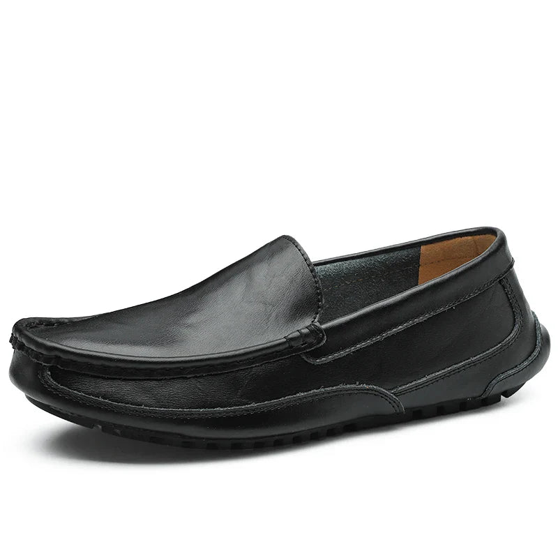 A black genuine leather loafer with visible stitching, a rounded toe, cushioned insole, and a low rubber sole, displayed against a white background.