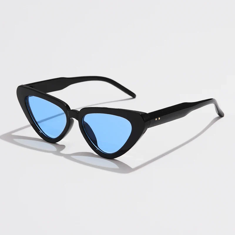 Black cat-eye sunglasses with blue tinted lenses, angled on a white surface, offer lightweight eyewear and UV400 sun protection for stylish comfort.