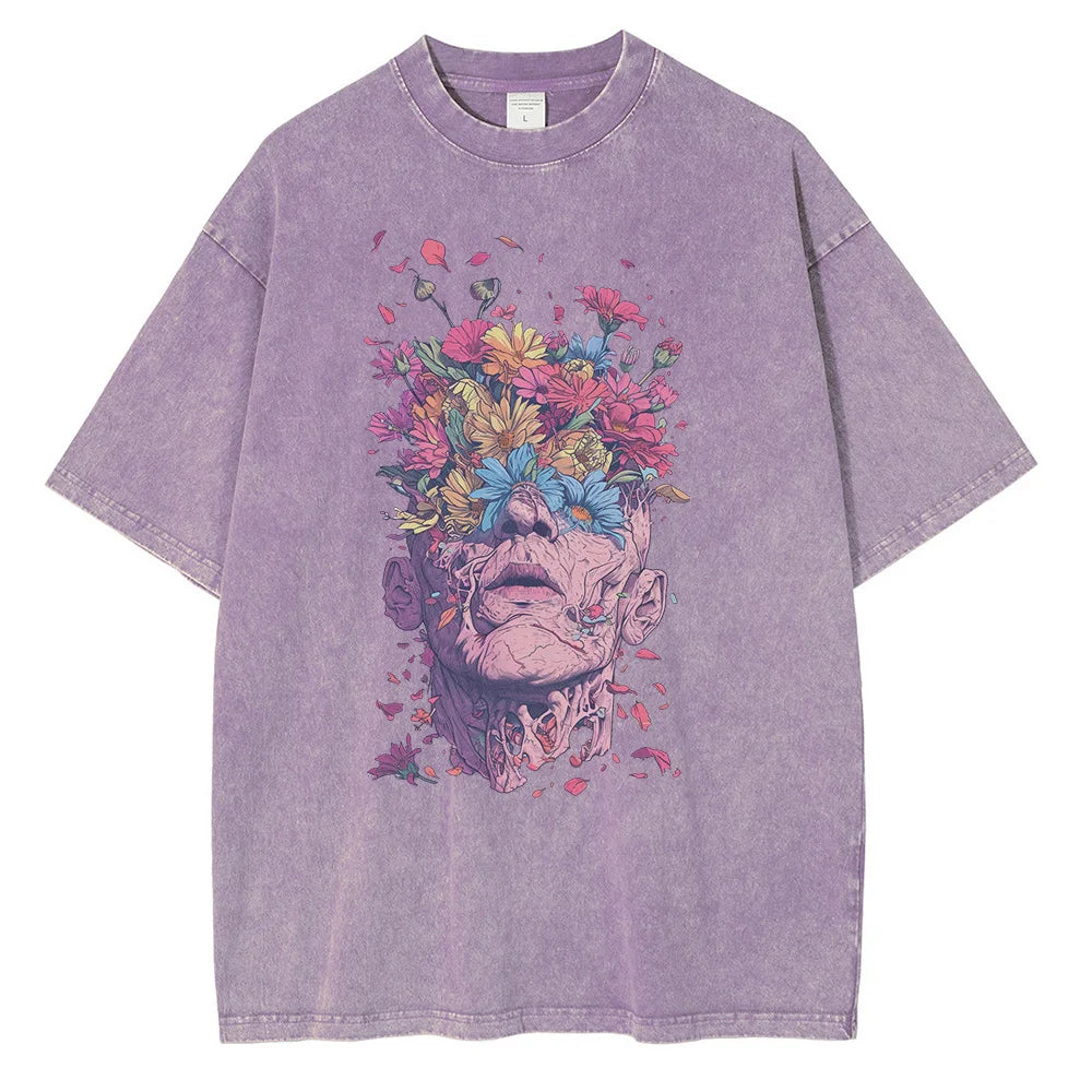 A lavender oversized fit t-shirt crafted from premium cotton, featuring striking graphic art of a human head with flowers blooming from the top, surrounded by colorful petals and leaves.