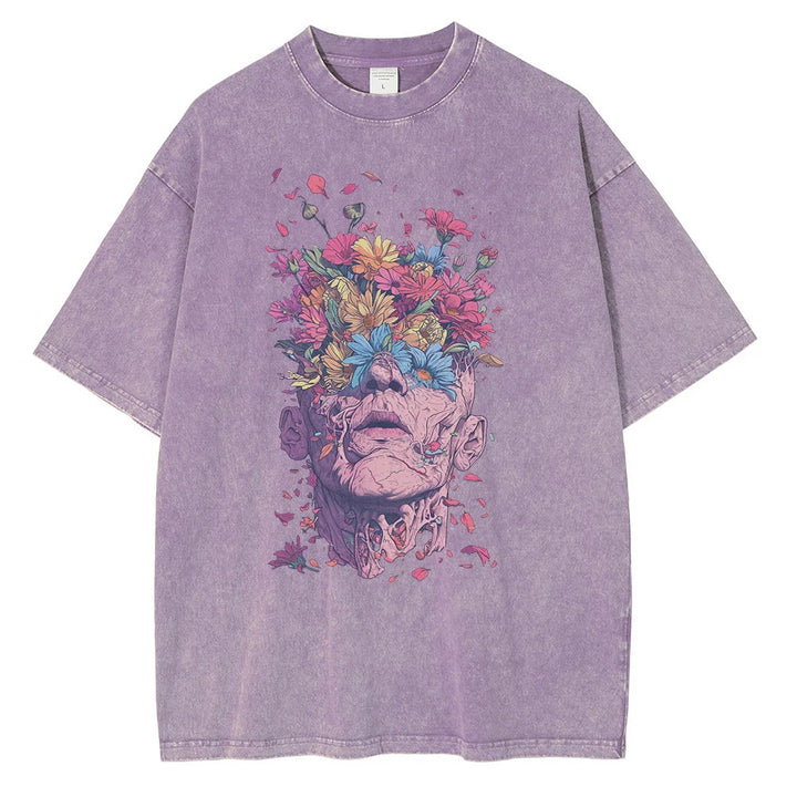 A lavender oversized fit t-shirt crafted from premium cotton, featuring striking graphic art of a human head with flowers blooming from the top, surrounded by colorful petals and leaves.