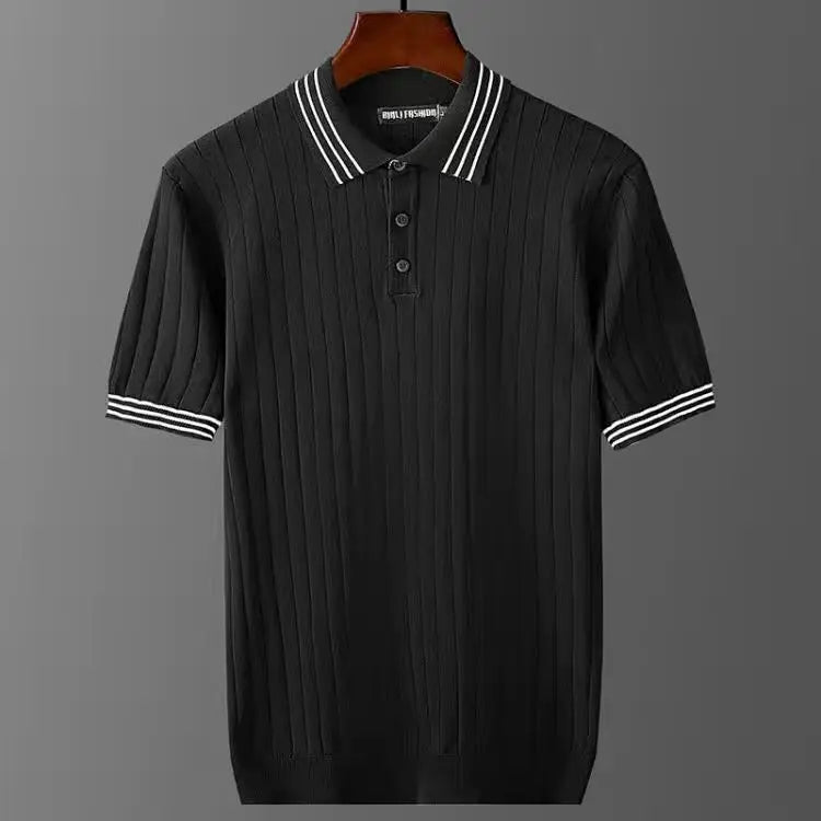 A premium polo shirt in black with vertical ribbed texture, button-up collar, and white stripes on the collar and sleeve cuffs, displayed on a hanger against a gray background.
