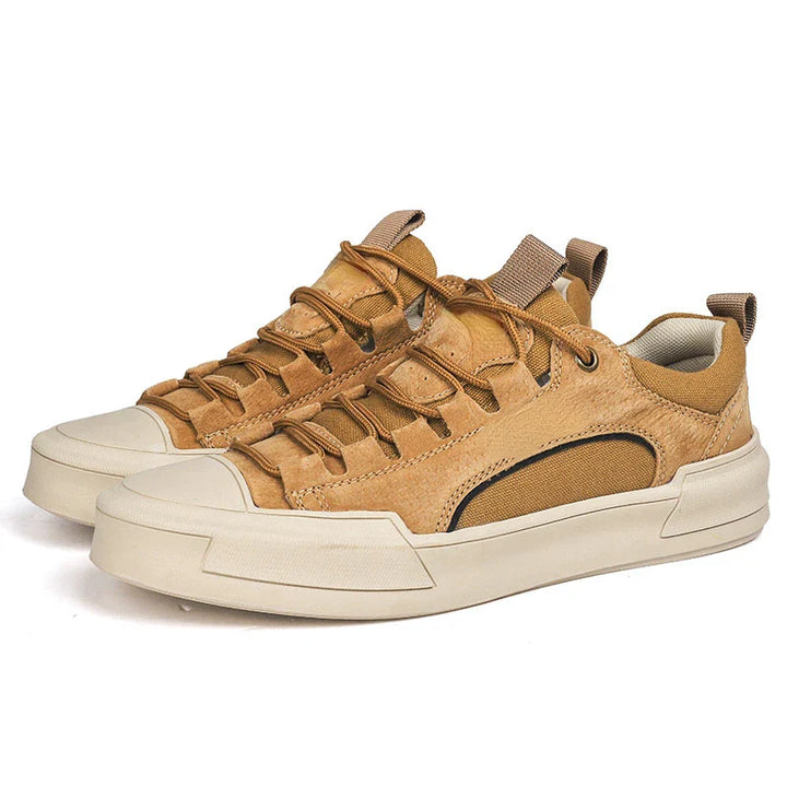 A pair of tan and beige casual sneakers with thick off-white soles, brown leather uppers, woven side details, cushioned insole for comfort, and pull tabs on the tongue and heel.