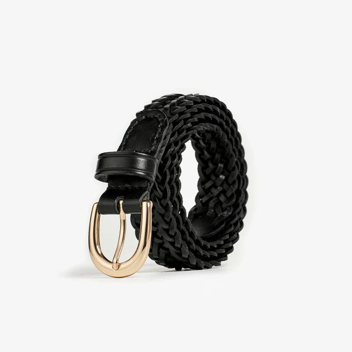 A black braided leather belt with a gold buckle, showcasing artisanal craftsmanship, is rolled up and displayed on a plain white background.