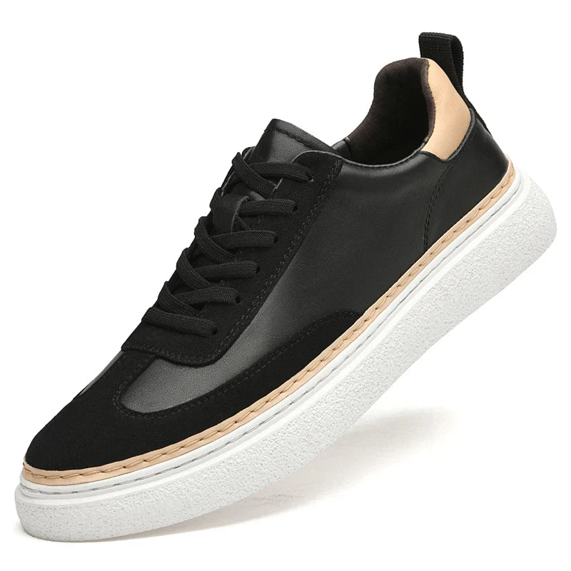 A black sneaker with black laces, a white textured sole, beige heel accent, and beige trim above the sole, crafted from genuine leather for durability and style, shown at an angle against a white background.