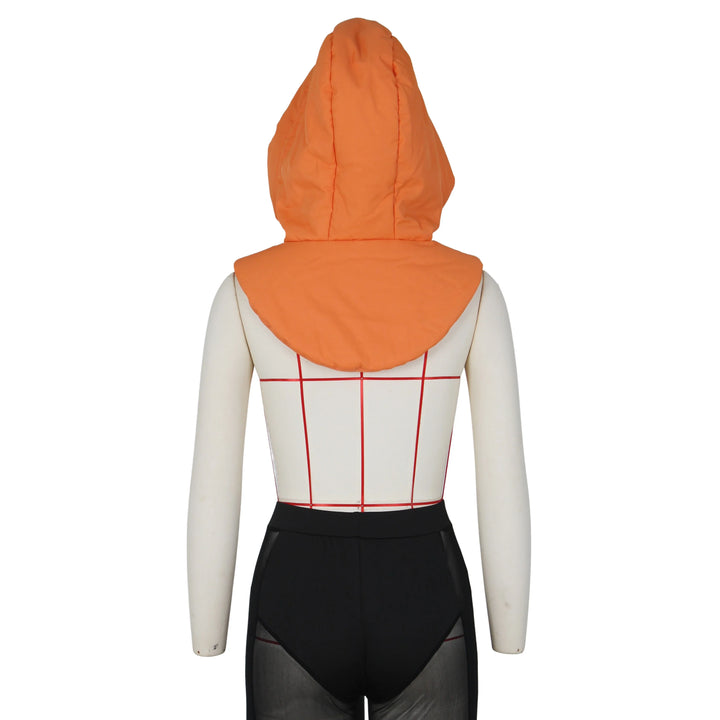 A mannequin wearing a sleeveless, white and red grid-patterned top, black sheer high-waisted shorts, and an oversized lightweight hooded design in orange, photographed from the back.