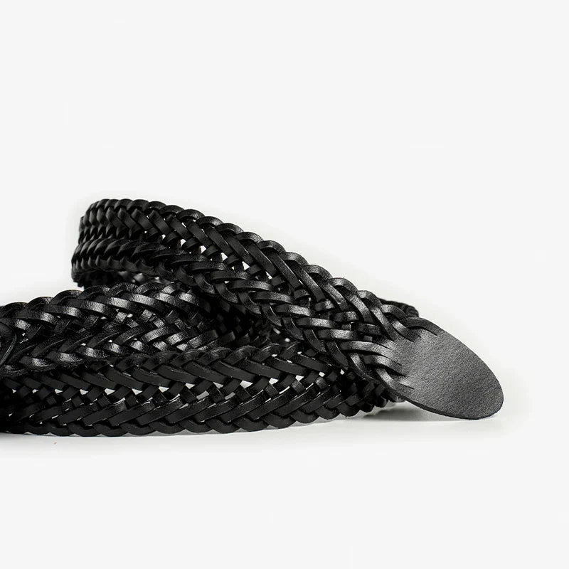 A coiled black braided Italian leather belt with a rounded tip, showcasing artisanal craftsmanship, displayed on a white background.