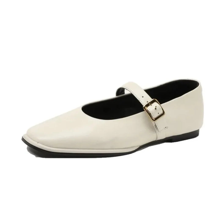 A single white Augusta Leather Ballet Flat with a rounded toe, low black sole, and buckle strap across the instep—an elegant example of sustainable shoes.