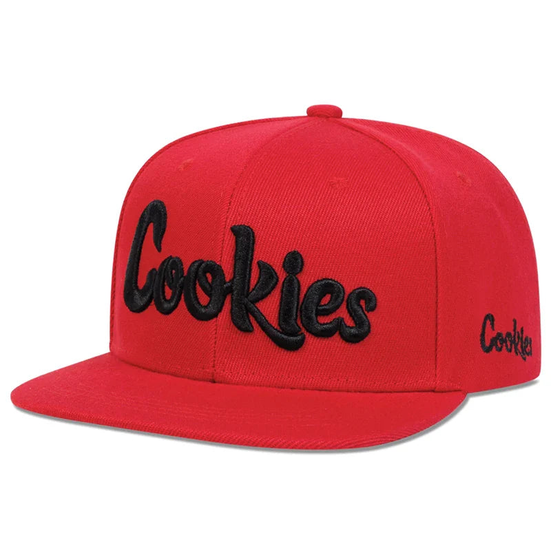 A red flat-brim hat with the word Cookies embroidered in large black letters on the front and smaller on the side, crafted from breathable fabric for comfort.