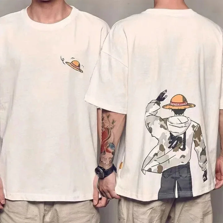 Front and back view of a white cotton knit crew neck T-shirt featuring a small straw hat graphic art on the front and a large illustration of a character in a straw hat and camouflage jacket on the back.