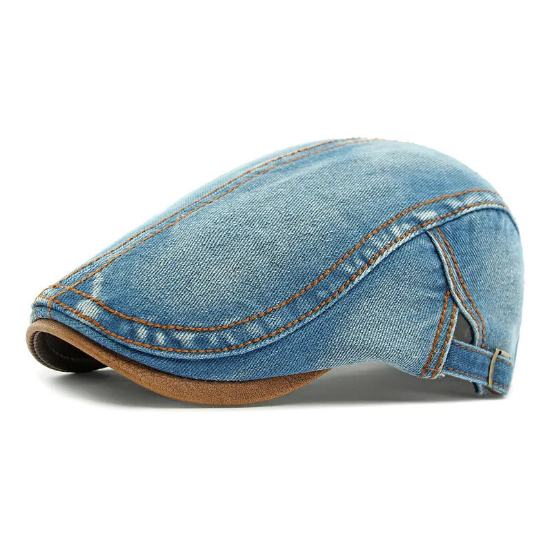 A light blue cotton denim flat cap with brown stitching and a brown underbrim, offering stylish sun protection, shown in a side profile view against a white background.