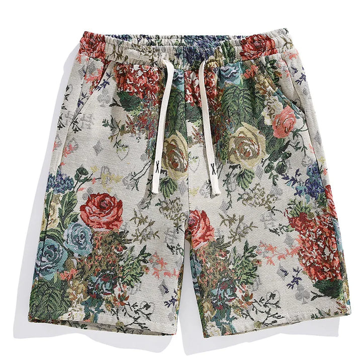 A pair of premium quality shorts with an elastic waistband and drawstrings, featuring a colorful floral tapestry pattern with roses and leaves on a light background.