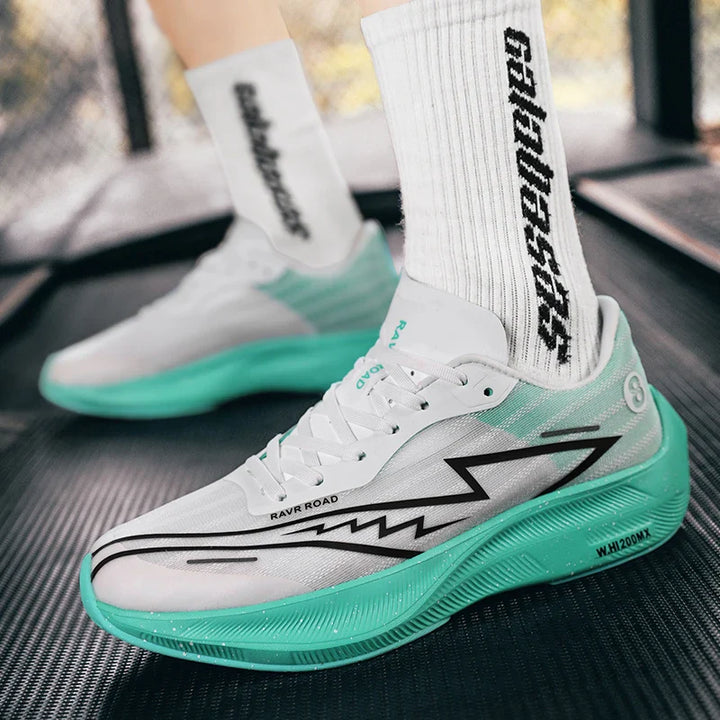 Close-up of a person wearing white running shoes with a black zigzag design and teal shock-absorbing sole, paired with white socks featuring black text. The scene unfolds in an indoor sports area.