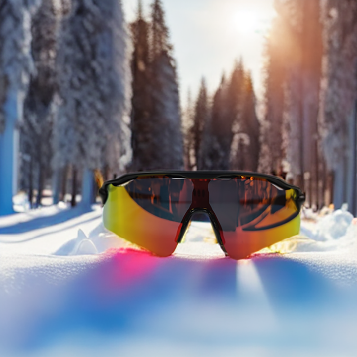 Sporty, reflective Polarized Cycling Sunglasses with orange-yellow lenses offering UV protection rest on snow in a sunlit, snowy forest, with tall evergreens and warm sunlight streaming through in the background.
