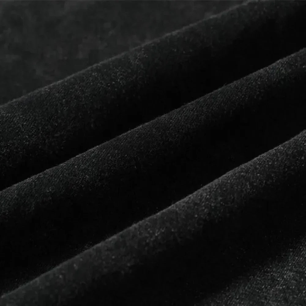 Close-up of black velvet fabric with soft texture, showing ridges and folds that highlight its smooth, luxurious surface—ideal for graphic design projects or pairing with an oversized fit.