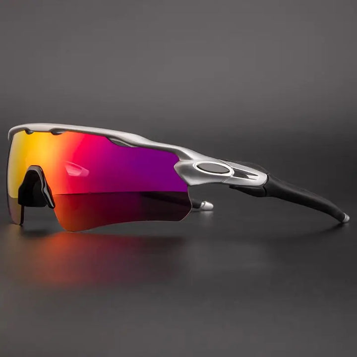 Sport sunglasses with a silver frame and a single large, mirrored lens featuring a gradient from red to purple, offering UV protection. Perfect as polarized cycling sunglasses, displayed against a plain dark background.