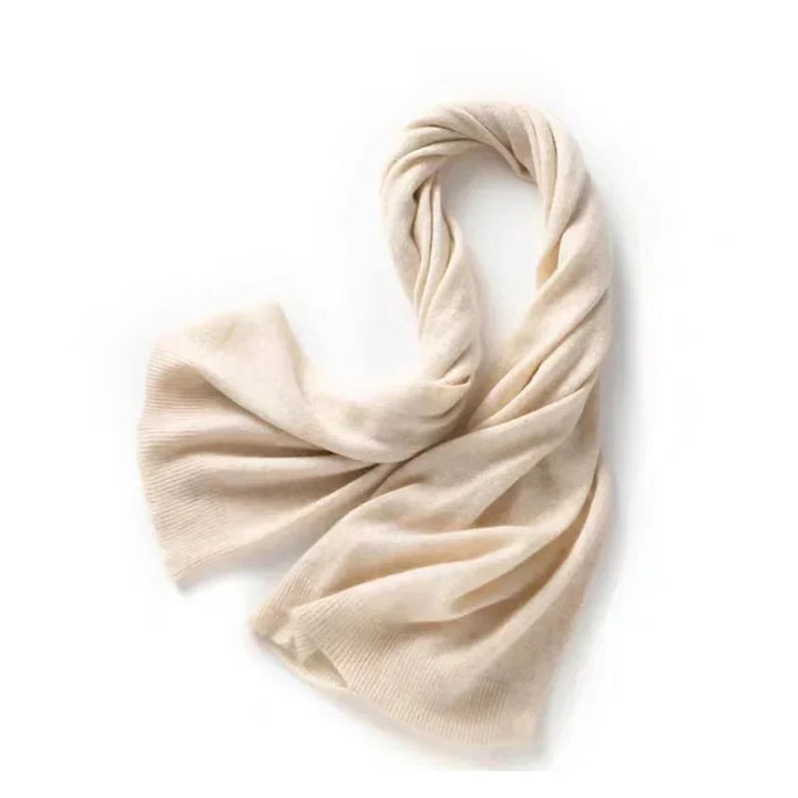 A soft, cream-colored cashmere blend scarf is loosely folded and laid out on a white background—perfect for autumn winter layering.