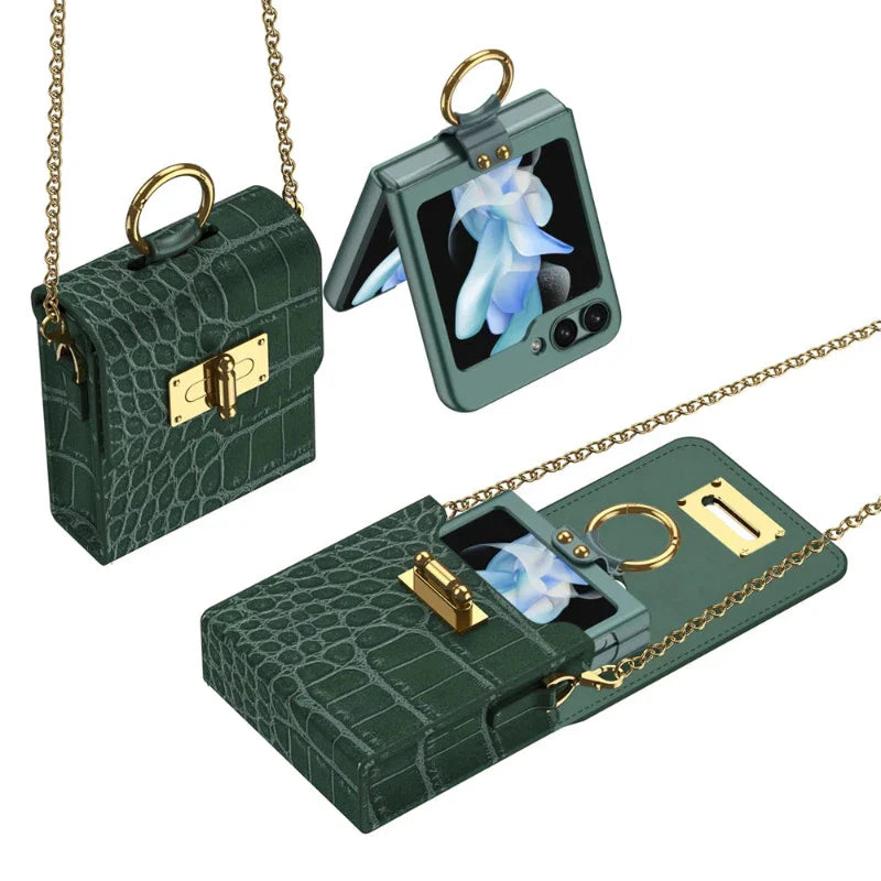 Small, dark green, crocodile-textured purse with a gold chain and clasp, shown open and closed, holding a foldable smartphone in a leather phone case with a blue flower on its screen.