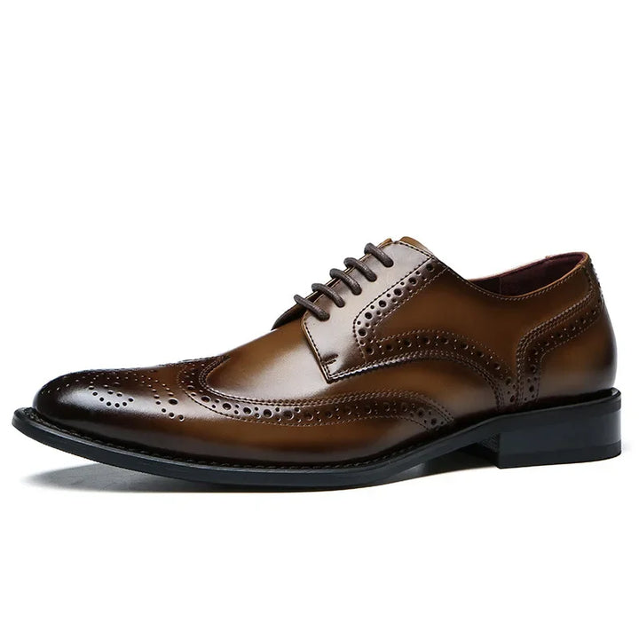 A premium leather brogue dress shoe with classic detailing features a closed lace-up design, cushioned insole, and a slip-resistant rubber sole, shown against a white background.