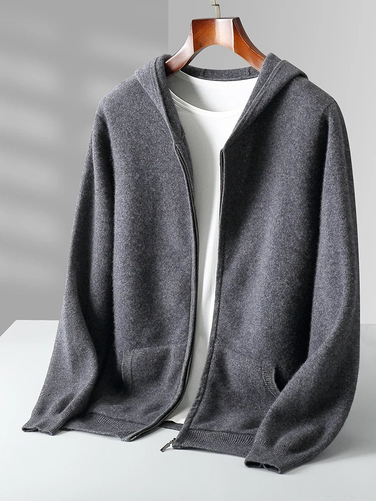 A dark gray zip-up hoodie with a hood, displayed on a hanger over a white shirt against a light gray background, perfect for layering as an autumn winter cardigan.