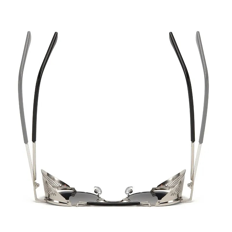 A pair of Steampunk sunglasses viewed from the front with the arms raised, showing silver frames, black tips, and reflective lenses. The design appears futuristic and angular with bold metallic vibes.
