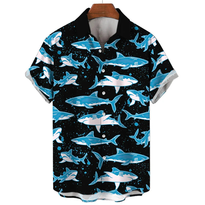 A summer-ready short-sleeve button-up shirt with a black background, featuring an ocean-inspired pattern of blue and white sharks swimming in various directions. The solid black collar adds contrast, and the shirt is displayed on a wooden hanger.