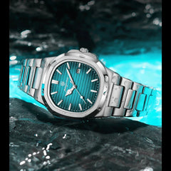 A silver wristwatch with a teal striped face and quartz movement rests on a wet, reflective surface, surrounded by blue light and water. The watch displays the date and features metal hour markers and a stainless steel bracelet.
