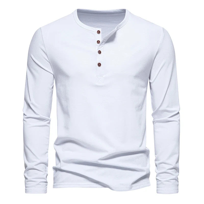 A classic design Henley shirt, this plain white long-sleeve features four brown buttons on the front placket. Crafted from breathable cotton, it’s displayed on a white background.