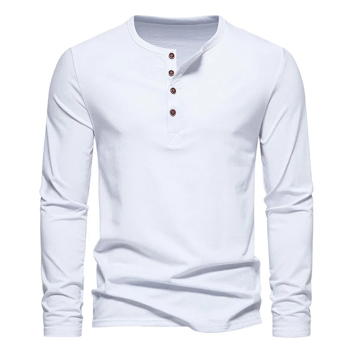 A classic design Henley shirt, this plain white long-sleeve features four brown buttons on the front placket. Crafted from breathable cotton, it’s displayed on a white background.